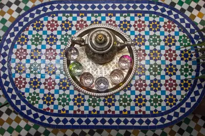 a bathroom sink on a mosaic tile floor at Riad Fes Allouch in Fès