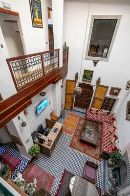 an overhead view of a living room with a staircase at Riad Fes Allouch in Fès