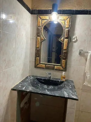 a bathroom with a sink and a mirror at Hotel le Touareg in Merzouga