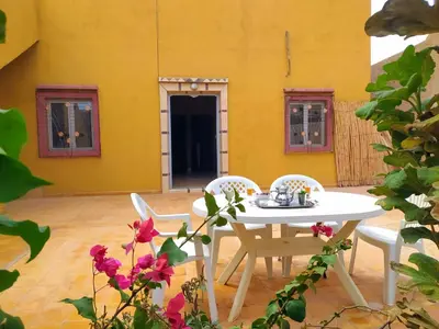 a patio with a white table and two chairs at Luxury apartment Hassilabied Merzouga in Hassilabied