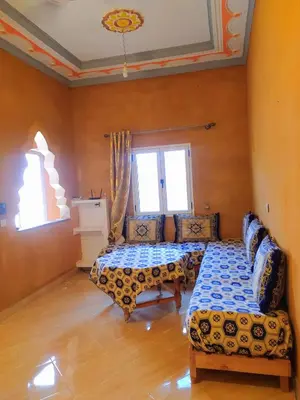 a living room with two beds and a couch at Luxury apartment Hassilabied Merzouga in Hassilabied