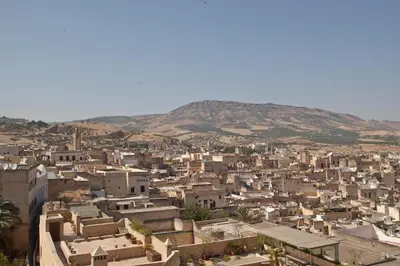 a city with buildings and mountains in the background at Riad Fes Palacete in Fès