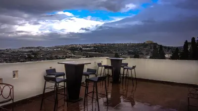 a group of bar stools sitting on a roof at Riad Fes Palacete in Fès