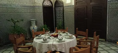 a table with a white table cloth on top of it at Riad Fes Palacete in Fès