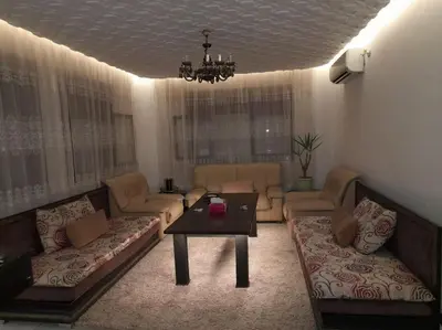 a living room with couches and a table at superbe appartement bien placé in Fès