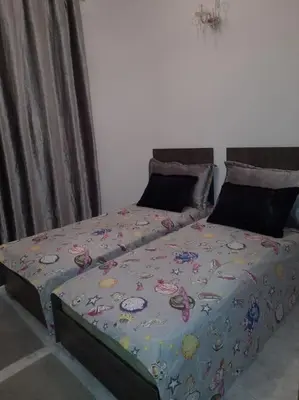 a bed with a comforter with hello kittypill at superbe appartement bien placé in Fès