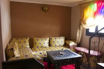 a living room with a couch and a table at Collier De La Colombe in Meknès