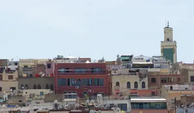 a group of buildings in a city with a clock tower at Collier De La Colombe in Meknès