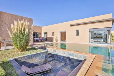 a swimming pool in the backyard of a house at Villa Sakina, piscine Chauffée, ping-pong, cuisinière in Marrakech