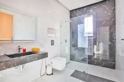 a bathroom with a shower and a toilet and a sink at Villa Sakina, piscine Chauffée, ping-pong, cuisinière in Marrakech