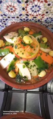 a bowl of soup with vegetables on a table at Hotel AZUL Todra Gorges in Tinerhir