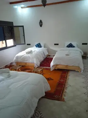 a room with three beds in a room at Hotel AZUL Todra Gorges in Tinerhir