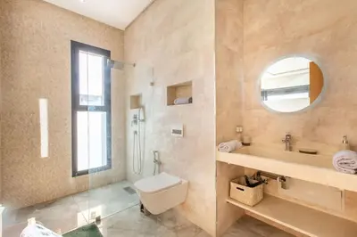 a bathroom with a toilet and a sink and a mirror at Villa Kassia , Jacuzzi, Hamman, jeux… in Marrakech