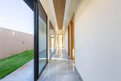 an external view of a hallway with sliding glass doors at Villa Kassia , Jacuzzi, Hamman, jeux… in Marrakech