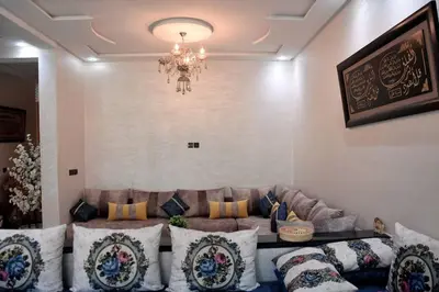 a living room with a couch and a chandelier at Appartement Azurite - Traditionnel & spacieux in Fès