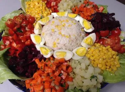 a plate of food with rice and vegetables on it at Riad Berber Merzouga in Merzouga