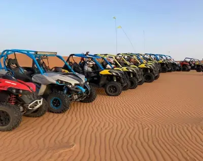 a row of atvs parked in the desert at Riad Berber Merzouga in Merzouga