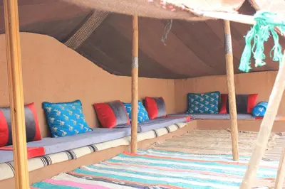 a group of pillows on a couch in a tent at Kasbah lucas in Akhendachou nʼAït Ouffi