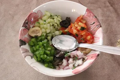 a bowl of vegetables with a spoon in it at Kasbah lucas in Akhendachou nʼAït Ouffi