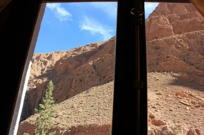 a view of a canyon from a window at Kasbah lucas in Akhendachou nʼAït Ouffi