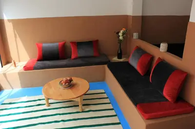 a small room with two beds and a table at Kasbah lucas in Akhendachou nʼAït Ouffi