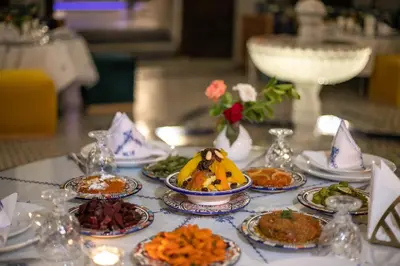 a table with many plates of food on it at Riad Fes Ziyat & Spa in Fès