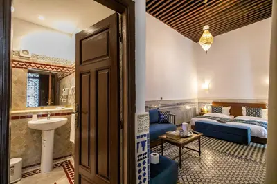 a hotel room with a bed and a bathroom at Riad Fes Ziyat & Spa in Fès