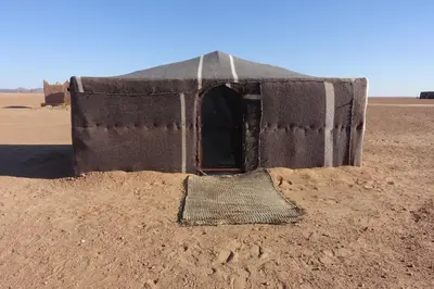 a small tent in the middle of the desert at Sahara Berber Camp - Mhamid Discovery Camp in Mhamid El Ghizlane