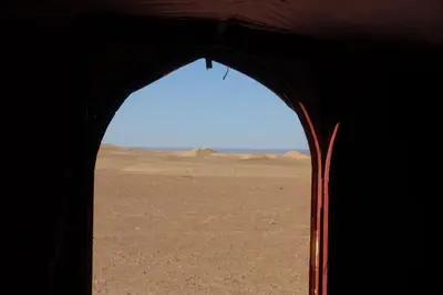 a view of the desert from the inside of a tent at Sahara Berber Camp - Mhamid Discovery Camp in Mhamid El Ghizlane
