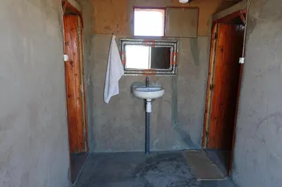 a small bathroom with a sink and a window at Sahara Berber Camp - Mhamid Discovery Camp in Mhamid El Ghizlane