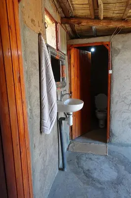 a bathroom with a sink and a toilet at Sahara Berber Camp - Mhamid Discovery Camp in Mhamid El Ghizlane
