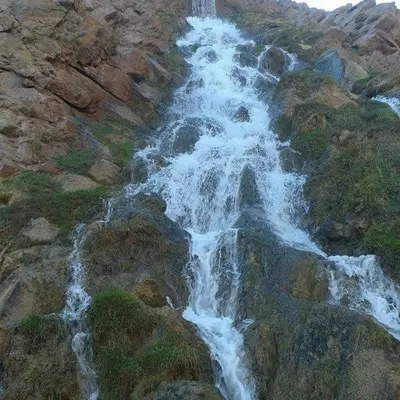 an aerial view of a waterfall on the side of a mountain at Auberge haut atlas in Tinerhir