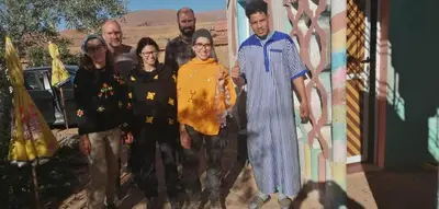 a group of people standing in front of a painting at Auberge haut atlas in Tinerhir