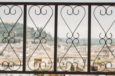 a view from a iron fence with a view of a city at Dar Chrif Idrissi in Fès