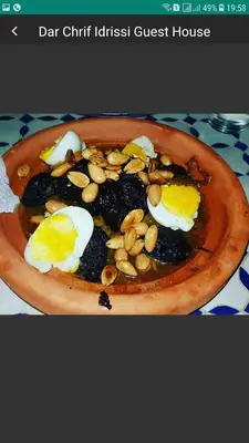 a plate of food with eggs and nuts on a table at Dar Chrif Idrissi in Fès
