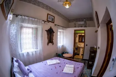 a small bedroom with a bed and a bathroom at Dar alhaja rahma in Fès