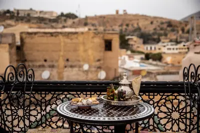 a table with a plate of food on a balcony at Dar alhaja rahma in Fès