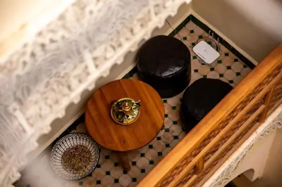 an overhead view of a table and bowls on a floor at Dar alhaja rahma in Fès