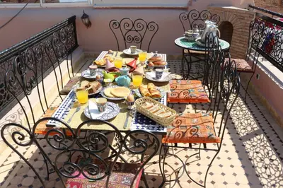 a table with plates of food on a balcony at Dar alhaja rahma in Fès