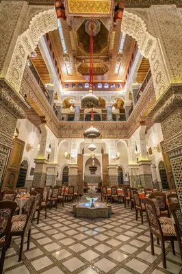a large room with tables and chairs in a building at Riad Fes Palais Bab Sahra & Cooking Workshops in Fès