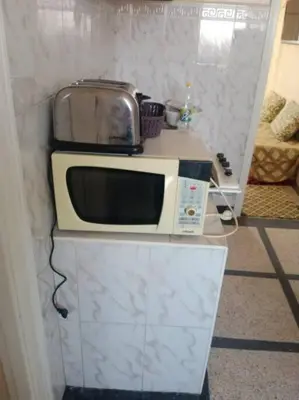 a microwave sitting on top of a counter at appartement au centre ville in Beni Mellal