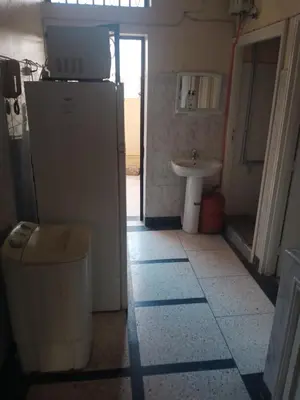 a small bathroom with a sink and a refrigerator at appartement au centre ville in Beni Mellal