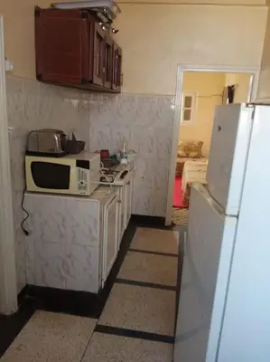 a kitchen with a microwave and a refrigerator at appartement au centre ville in Beni Mellal