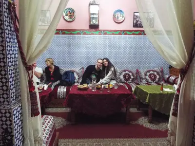 a group of people sitting at a table in a restaurant at Maison Adam in Fès