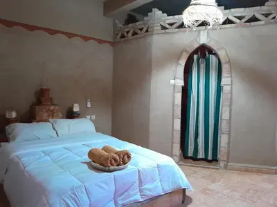 a bedroom with a bed with a bowl on it at SANDSTAR PALACE in Merzouga
