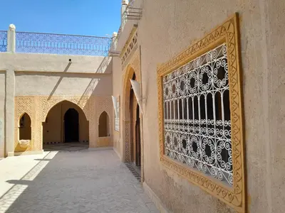 a building with a gate in a courtyard at SANDSTAR PALACE in Merzouga
