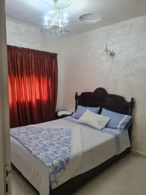 a bedroom with a bed with a red curtain at Appart. Bien équipé centre ville in Fès