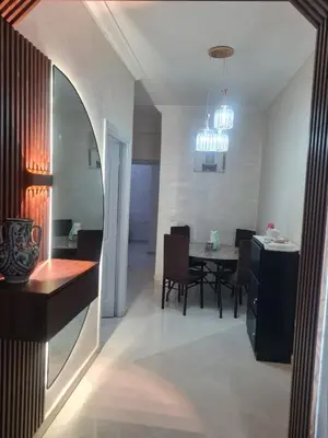 a kitchen and dining room with a table and chairs at Appart. Bien équipé centre ville in Fès