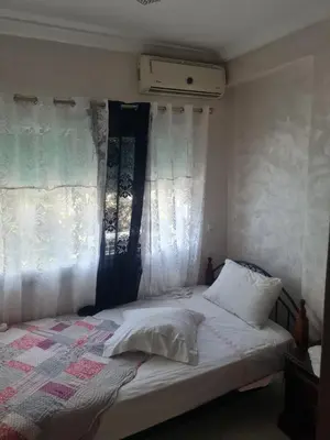 a bedroom with a bed with white curtains at Appart. Bien équipé centre ville in Fès