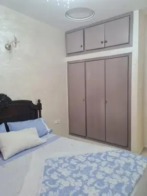 a bedroom with a bed with a large closet at Appart. Bien équipé centre ville in Fès